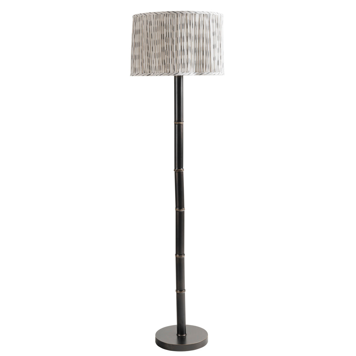 Full view of the unlit floor lamp with a patterned ivory pleated shade, dark segmented stem and circular base.