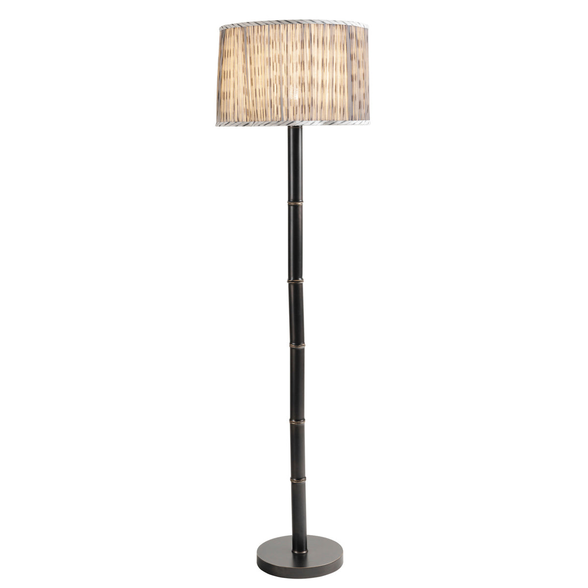 Full view of the floor lamp switched on, with warm light showing through the patterned pleated shade.