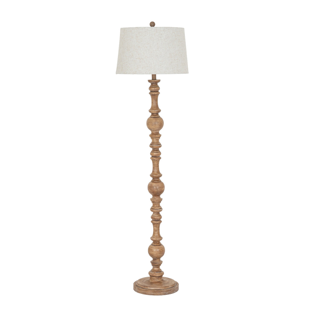 Full view of the Bead & Spindle Floor Lamp with a warm-brown shaped shaft, round base and pale tapered shade.
