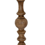 Detail of a rounded bead between narrow spindle shapes on the lamp shaft, with varied brown tones and pale surface markings.