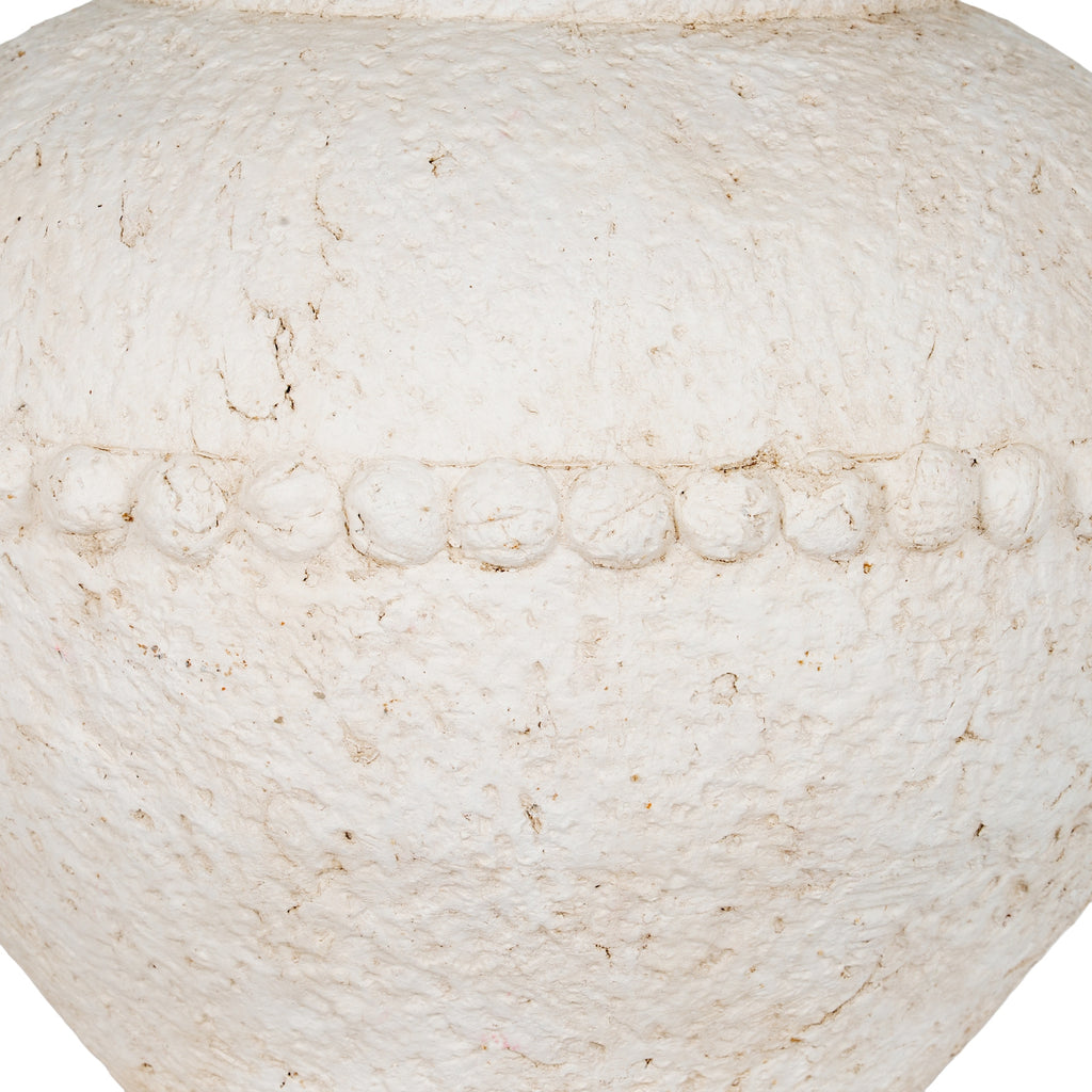 Detail of the rounded bead band across the vase body, with warm brown recesses in the uneven off-white surface.