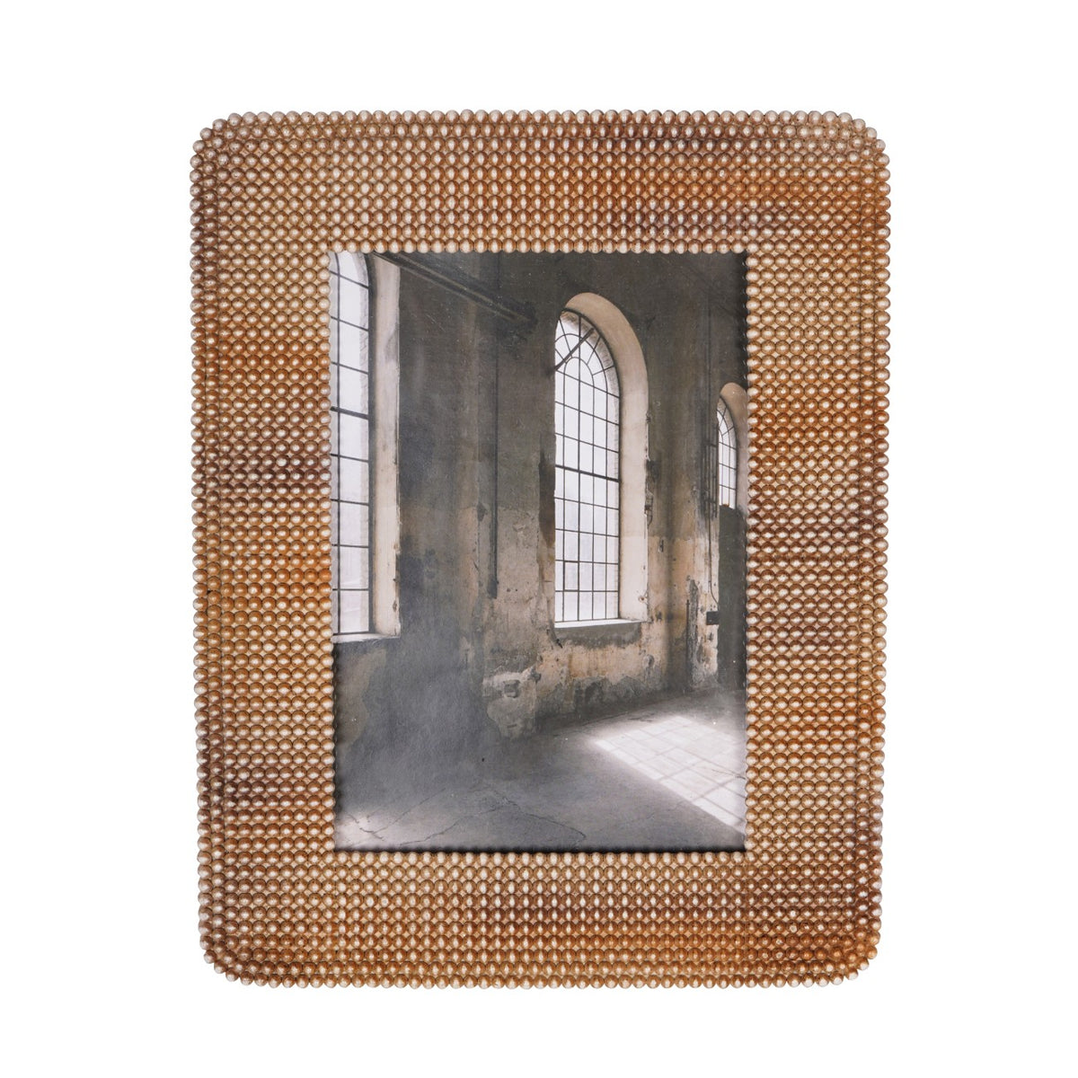 Front view of the brown photo frame showing its broad beaded border around a photograph of arched windows.