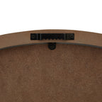 Rear detail of the clock showing a black sawtooth hanging bracket screwed to the brown backing near the top edge.