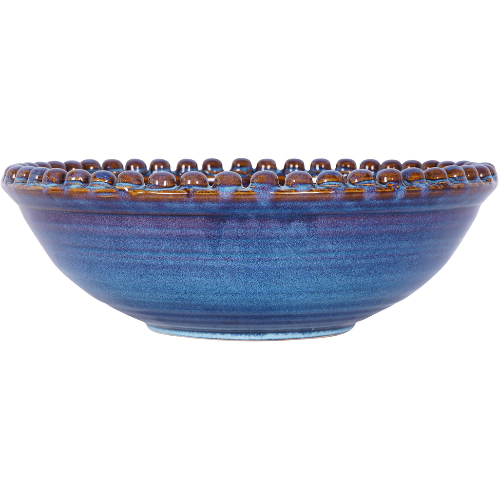 Side view of the blue bowl showing its low curved profile, narrow circular foot and raised beads around the rim.