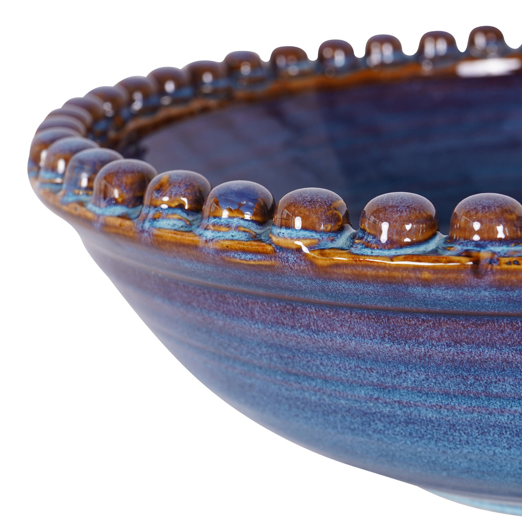 Close-up of the ceramic beads along the bowl's rim, showing glossy brown tops and blue glaze around their bases.