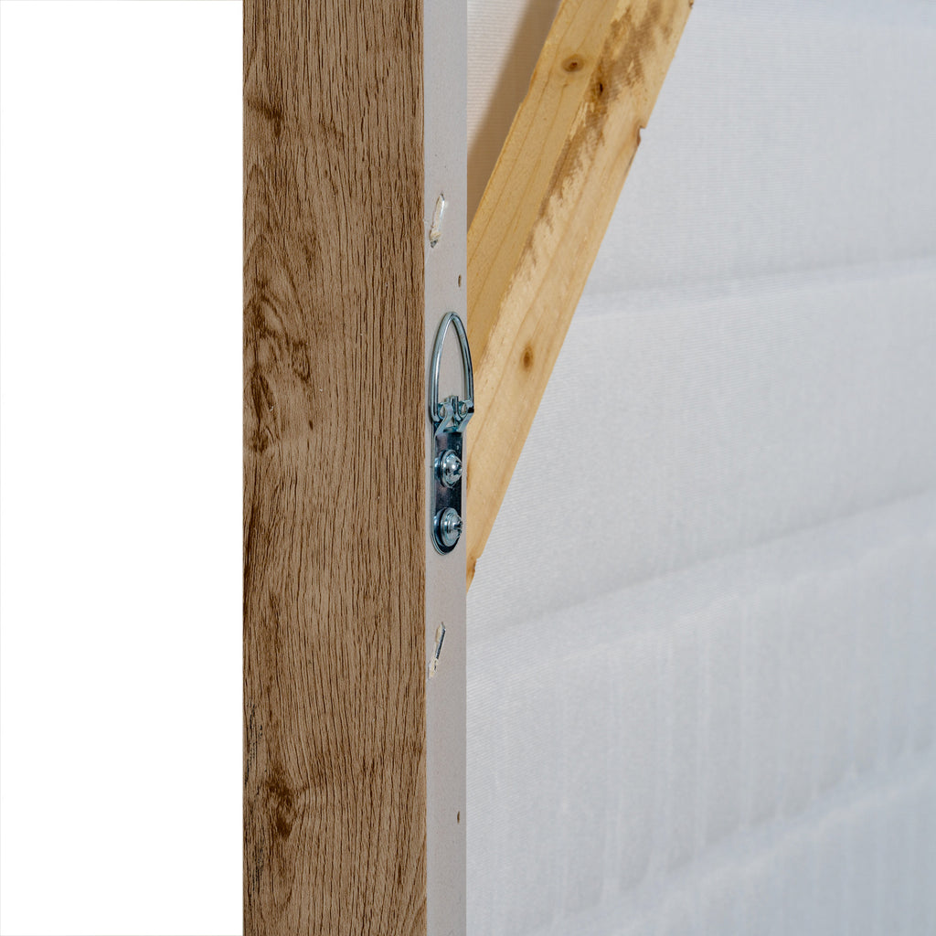 Rear edge close-up showing a silver-coloured loop secured with two screws beside a diagonal brace and the wood-grain outer frame.