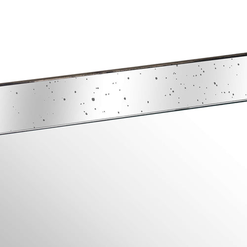 Close-up of the tray's mirrored inner side with scattered dark speckles, a slim distressed rim and the reflective base below.