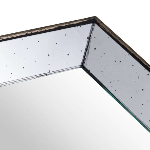 Close-up of a tray corner where two speckled mirrored sides meet above the smooth mirror base, with the weathered frame along the top edge.