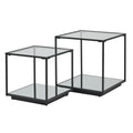 Two black framed side tables on a white background, with the shorter table in front and square reflective surfaces above and below.