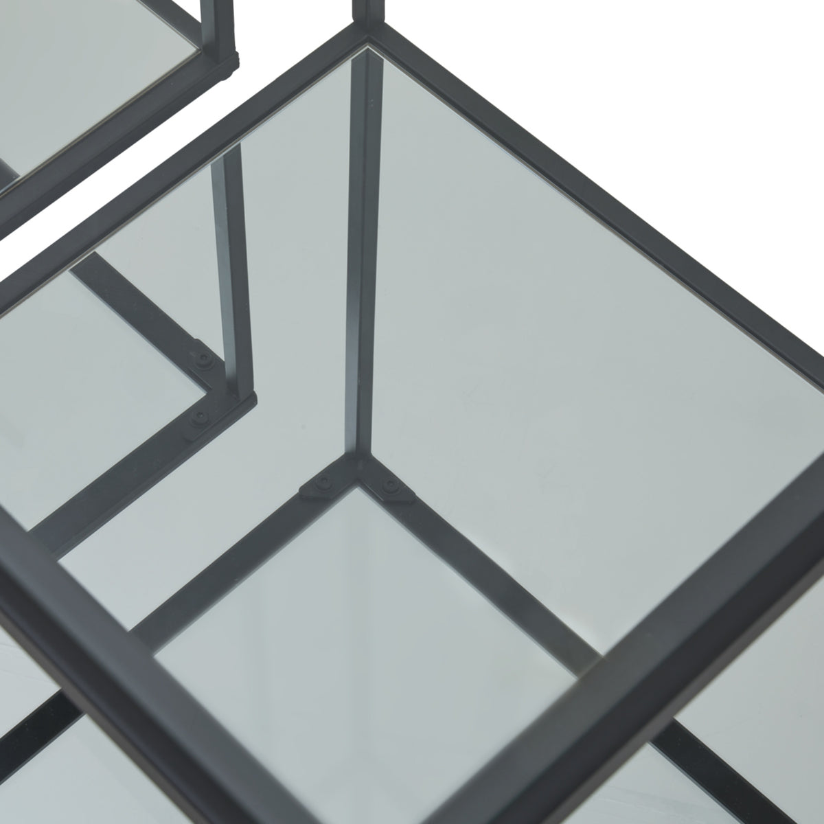 Angled close-up of a reflective lower shelf, with black frame edges and upright reflections forming intersecting lines.