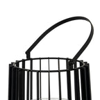 Angled close-up of the black lantern's tilted handle and round side attachment, above the circular rim and vertical frame.