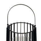 Close-up of the lantern's upright arched handle and circular open top, showing the broad fins between slender vertical rods.