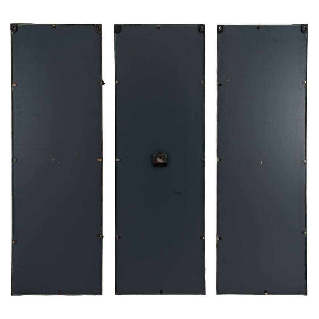 Rear view of three black-backed clock panels, showing hanging hardware near the top and the mechanism on the central panel.