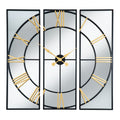 Front view of the mirrored wall clock, with a circular black dial spanning three rectangular frames and gold-coloured Roman numerals and hands.