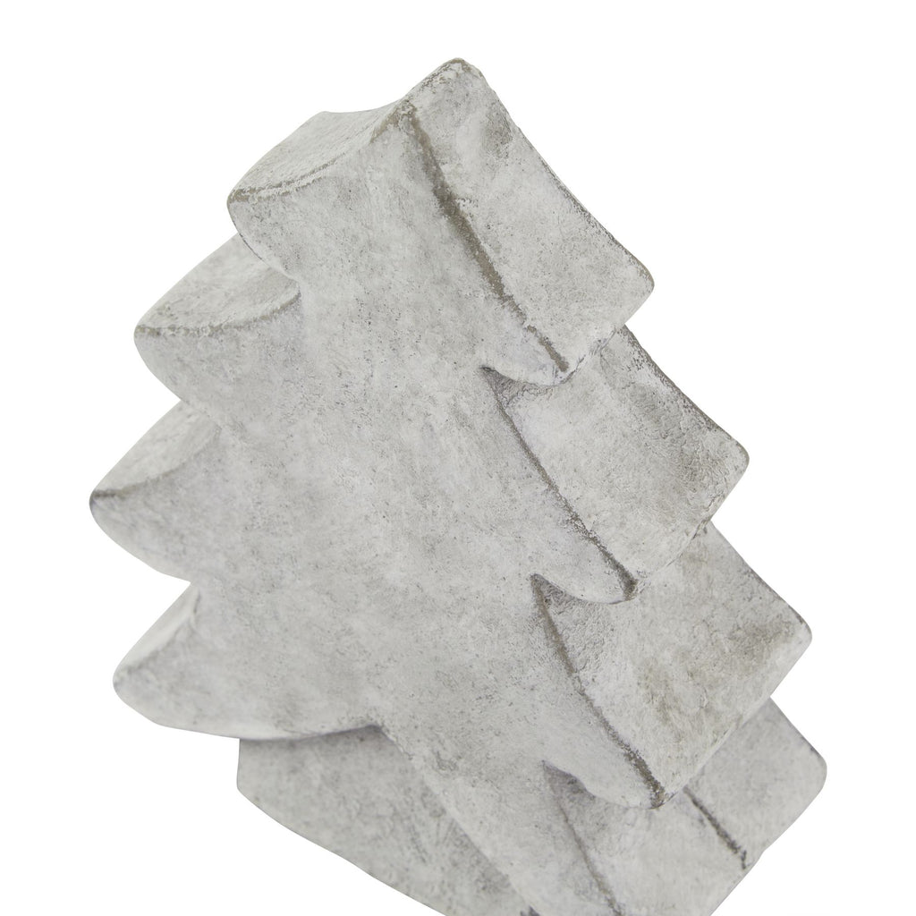 Angled close-up of the tree ornament's pointed top and broad branch tiers, showing mottled white-grey colouring and darker edges.