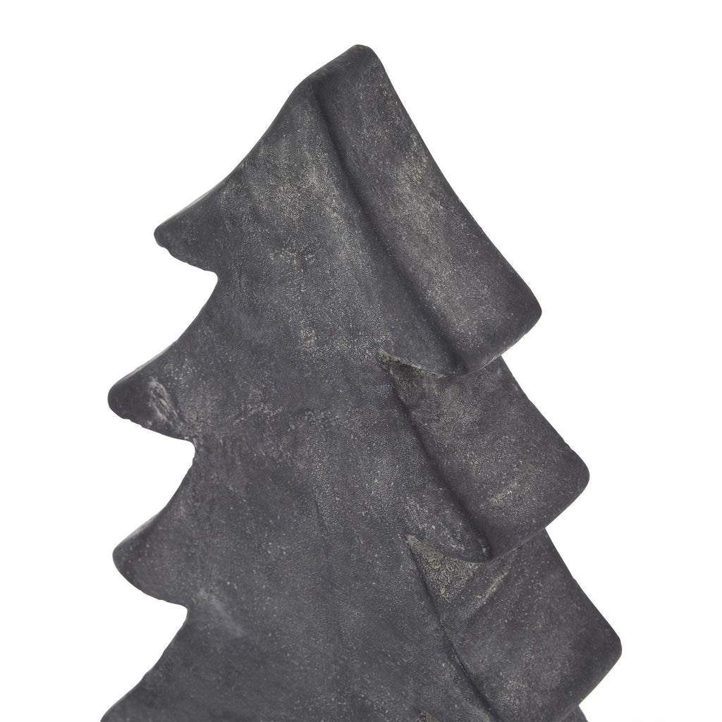 Close-up of the tree ornament's pointed top and sweeping upper branch tiers, with fine pale mottling across the dark surface.
