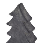 Close-up of the tree ornament's pointed top and sweeping upper branch tiers, with fine pale mottling across the dark surface.