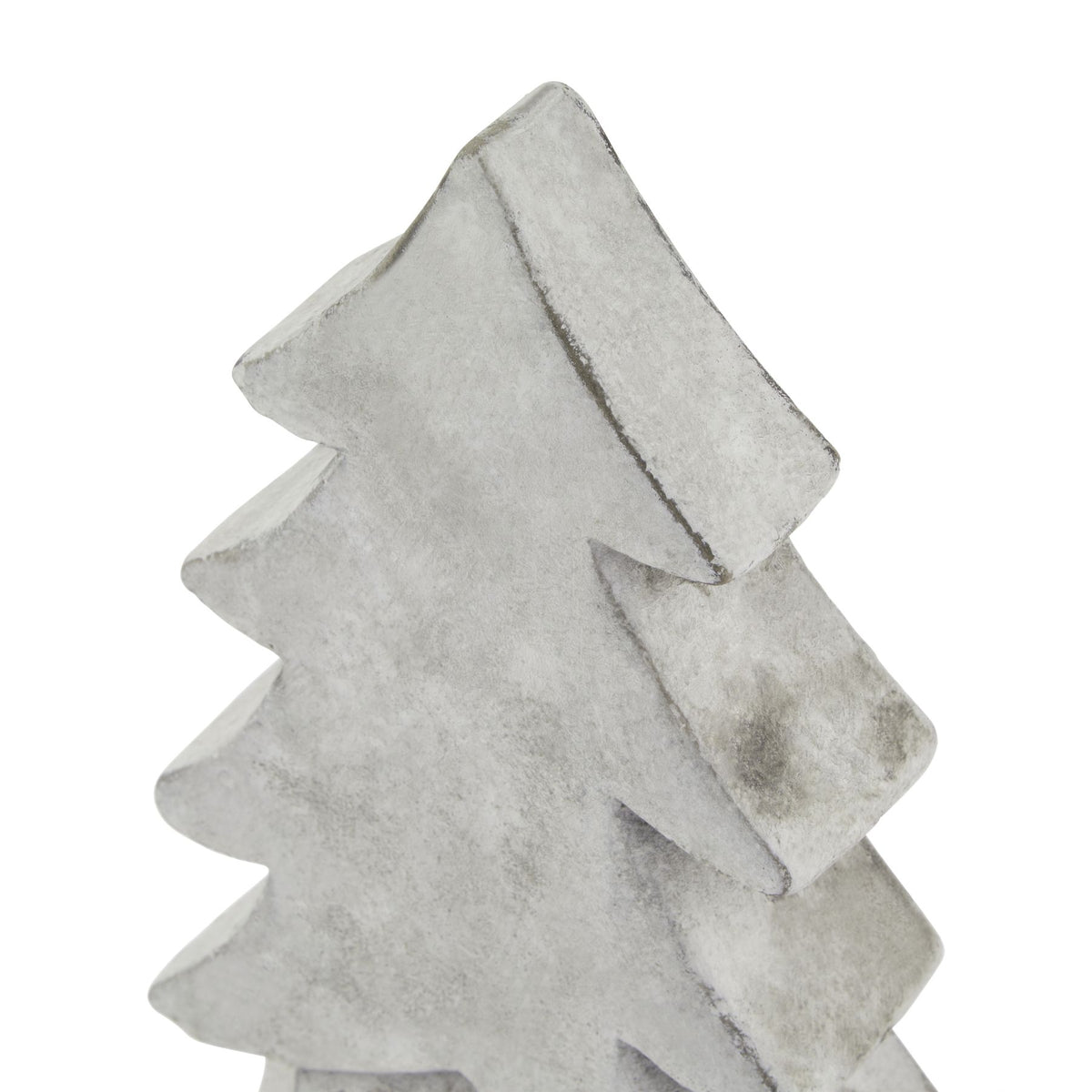 Close-up of the tree ornament's pointed top and thick curved branch edges, with grey mottling across the pale surface.