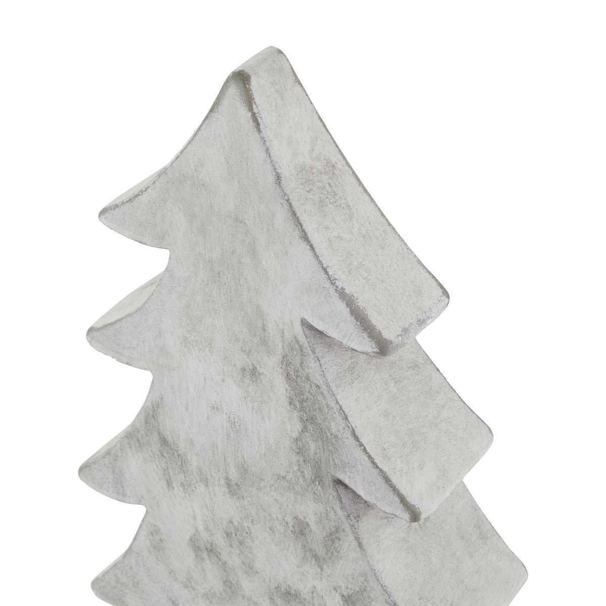 Close-up of the tree ornament's pointed top and curved branch tips, showing grey streaks and darker marks along the thick edges.