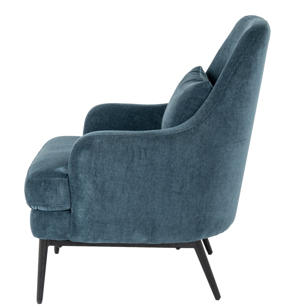 Side view of the blue armchair showing the curved arm rising into the tall back and the angled black rear legs.