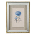 Front view of portrait framed artwork showing a large blue bloom and smaller flower with grey leaves, a beige textured surround and a broad pale bevelled border edged in distressed golden-brown.