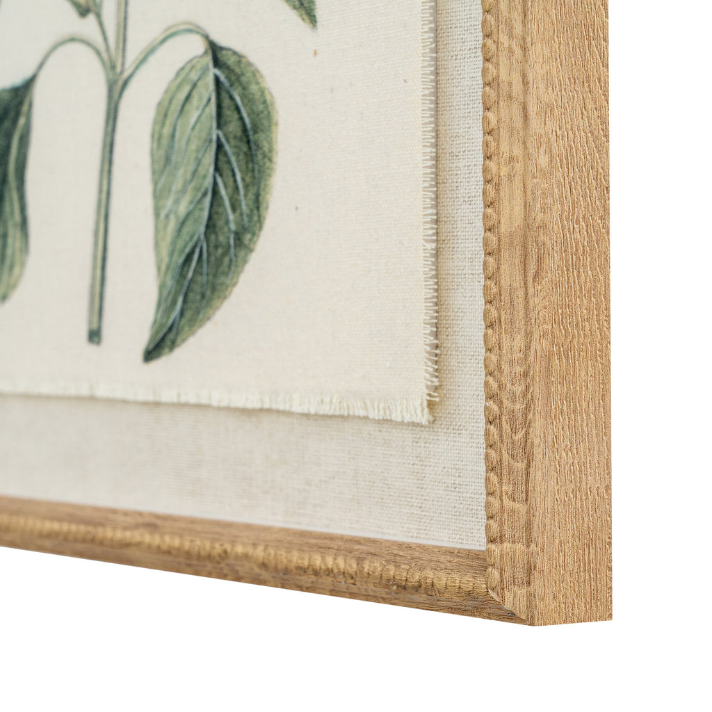 Angled close-up of the print's lower right corner, showing a green leaf, the lightly fringed edge of the image, pale woven-looking surround and beaded tan-gold frame.