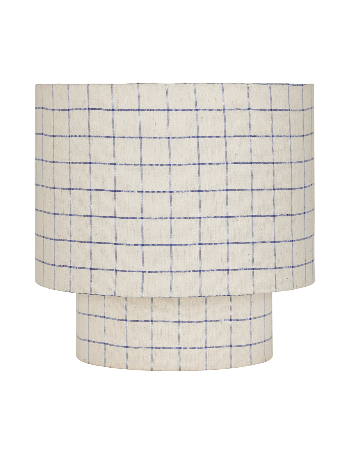 Front view of a table lamp with a broad drum shade and short cylindrical base, both covered in natural-toned fabric with fine blue checks, on white.