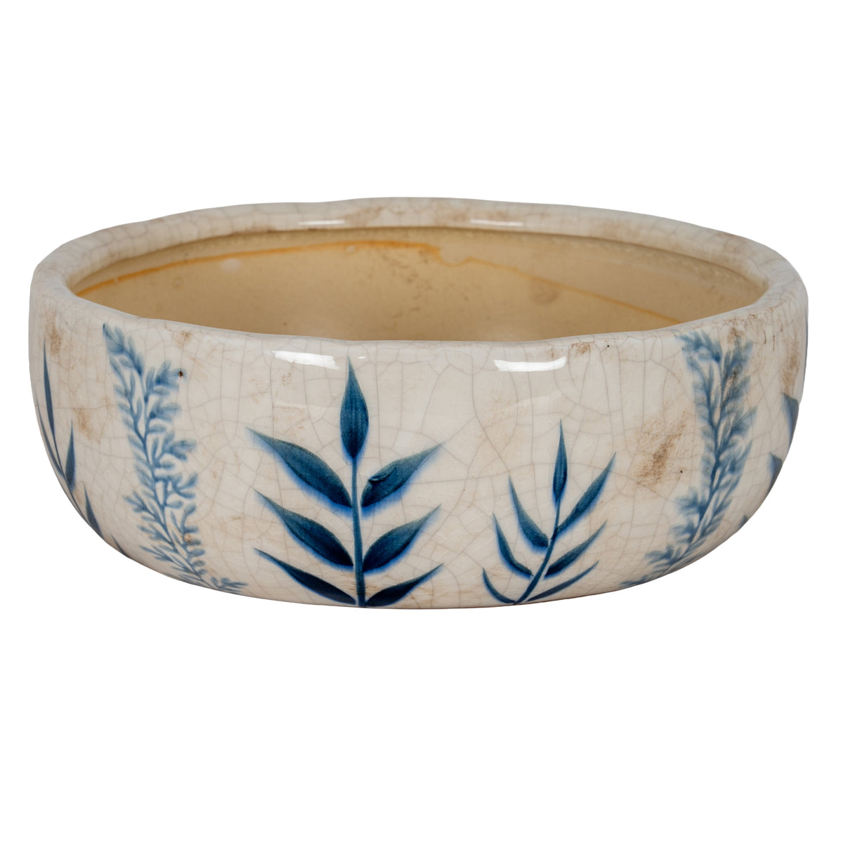 Low bowl planter with dark and pale blue leafy stems on an off-white crackle-patterned exterior, viewed from the front with its beige interior visible.
