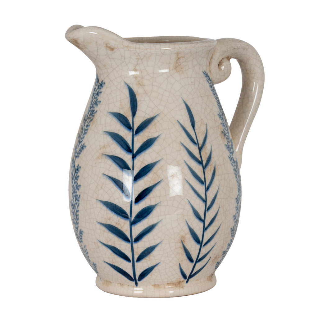 Full view of a cream jug-shaped vase with blue leafy stems, a projecting lip, rounded handle and short footed base.