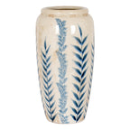 Tall tapered vase with upright blue botanical stems on an off-white crackle surface, shown in full against white.