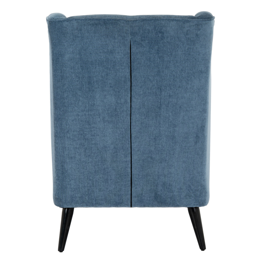 Rear view of the blue wing armchair with a central vertical seam, piping along the top edge and two visible black legs.