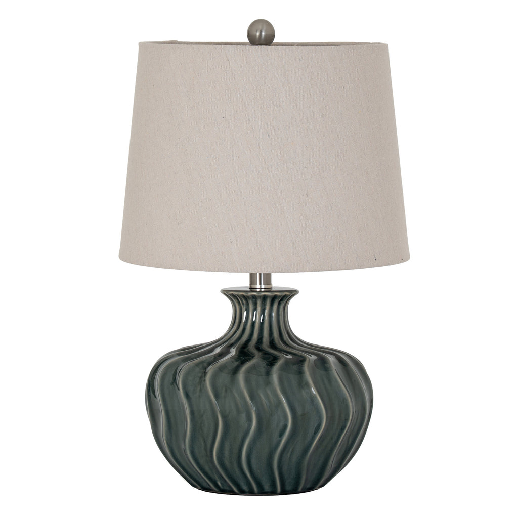 Bluegreen Waveflute Table Lamp with a rounded dark blue-green body, flowing vertical flutes and a pale tapered shade against white.