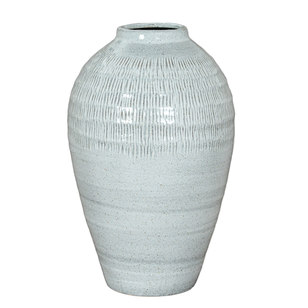 Pale blue-white vase shown in full against white, with rounded shoulders, an incised upper band and a tapered lower body.