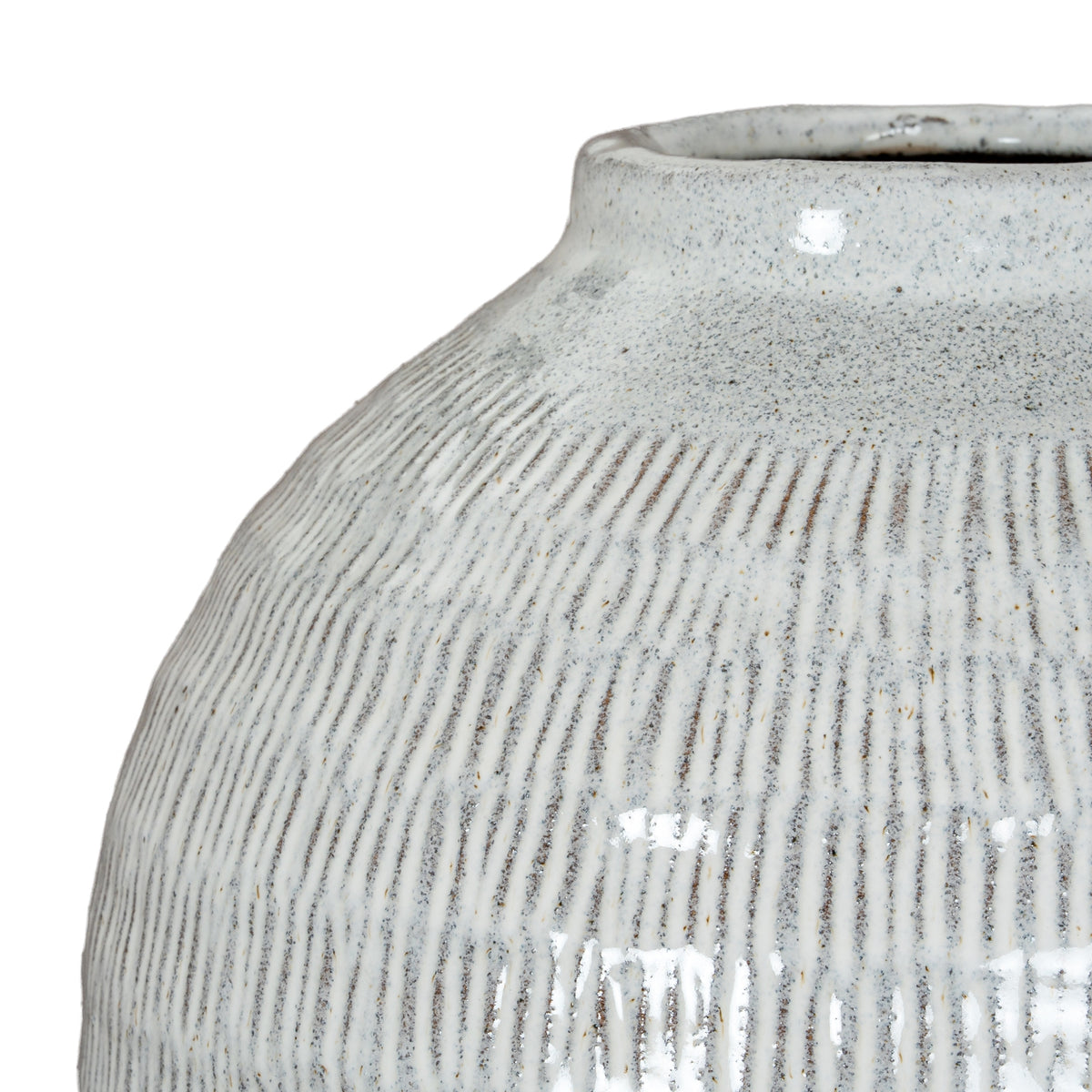 Close-up across the vase shoulder, showing darker incised lines beneath the pale glossy glaze and fine scattered speckles.