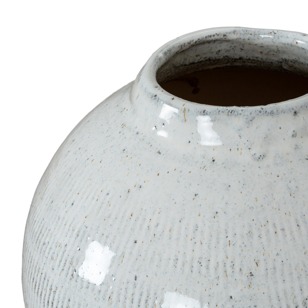 Angled close-up into the vase opening, showing the rounded rim, dark interior and speckled glossy glaze across the neck and shoulder.