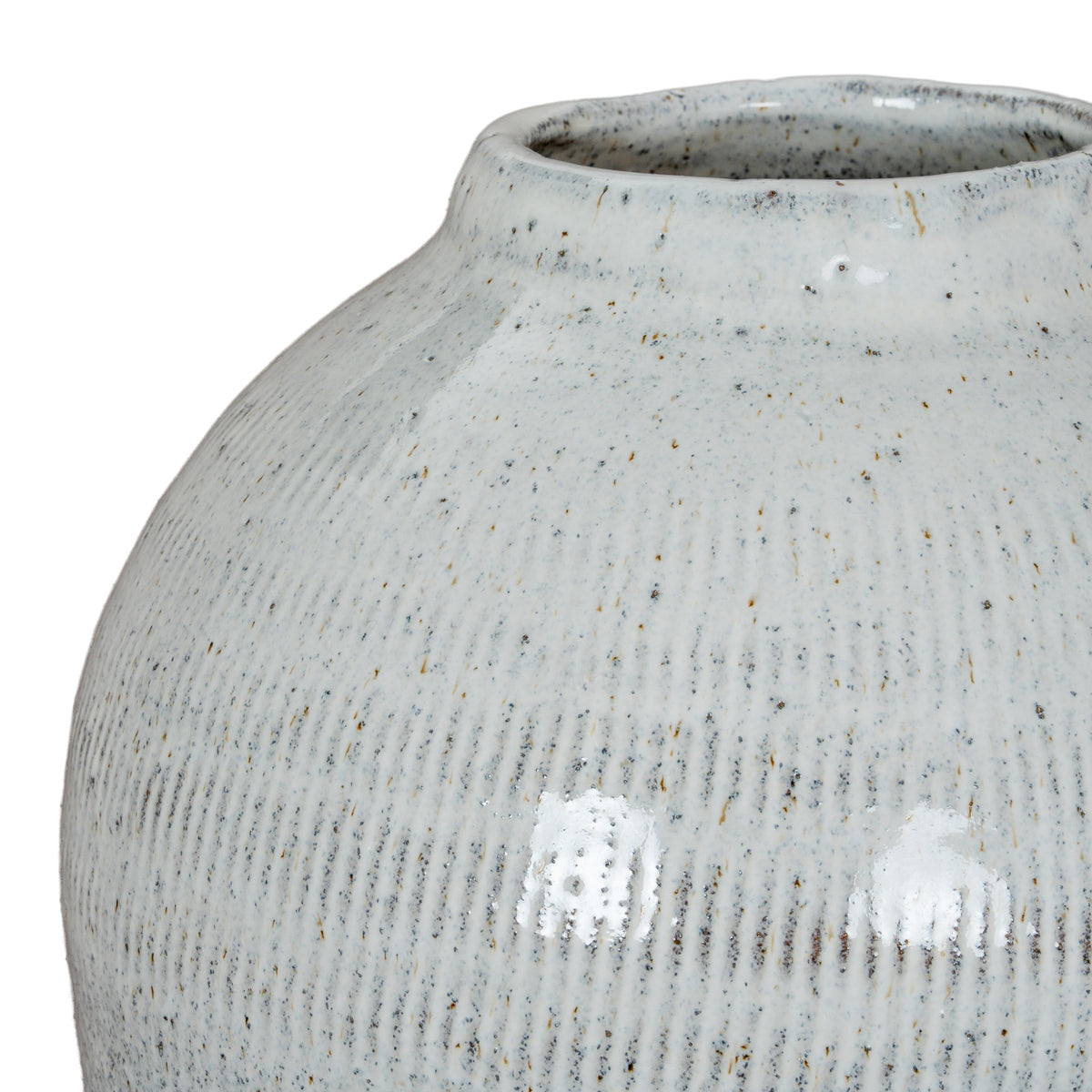 Close-up of the vase shoulder and upper body, with fine vertical incised lines visible beneath the pale speckled glaze.