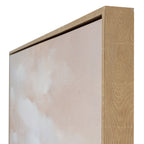 Angled detail of the upper right frame corner, showing its warm grain-like finish beside the blush canvas surface.