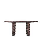 Side view of the marble coffee table showing the slim rounded tabletop edge and bobbin legs beneath.