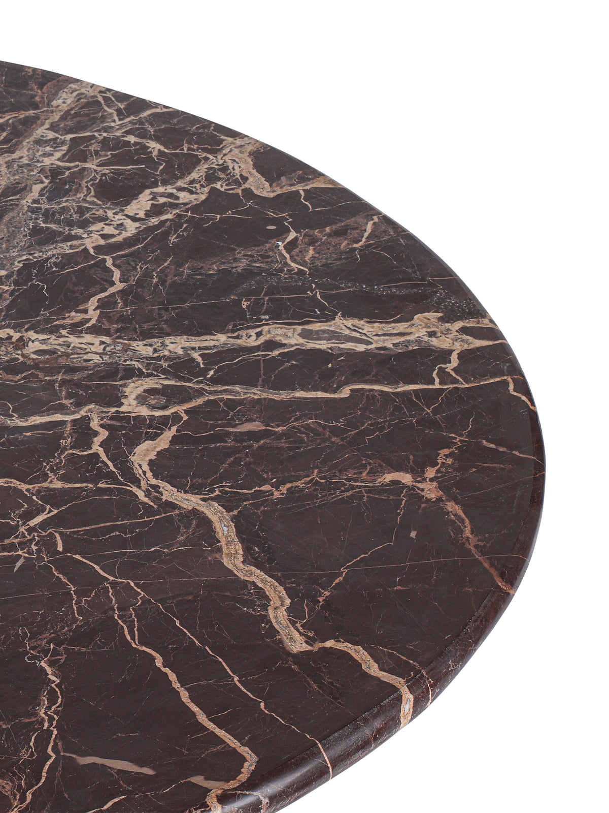 Close-up of the marble tabletop with pale irregular veining and a softly rounded outer edge.