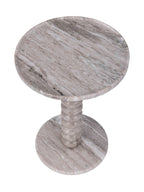 View from above of the marble side table, showing diagonal veining across its round top and circular base.