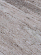 Close-up of the marble surface with cream bands, beige markings and grey veining.