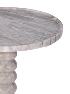 Detail of the round marble tabletop with its gently raised edge and the curved upper section of the bobbin pedestal.