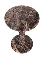 Elevated view of the red marble table showing pale veining across the circular top and base.