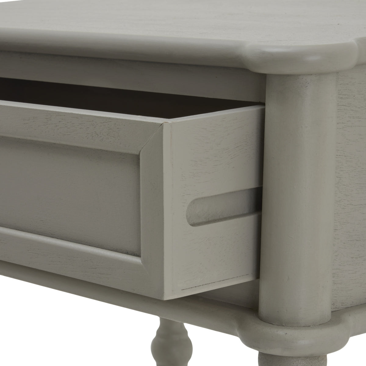 Close view of the partly open drawer, showing its dark interior, recessed horizontal groove on the side and pale grey grain texture.