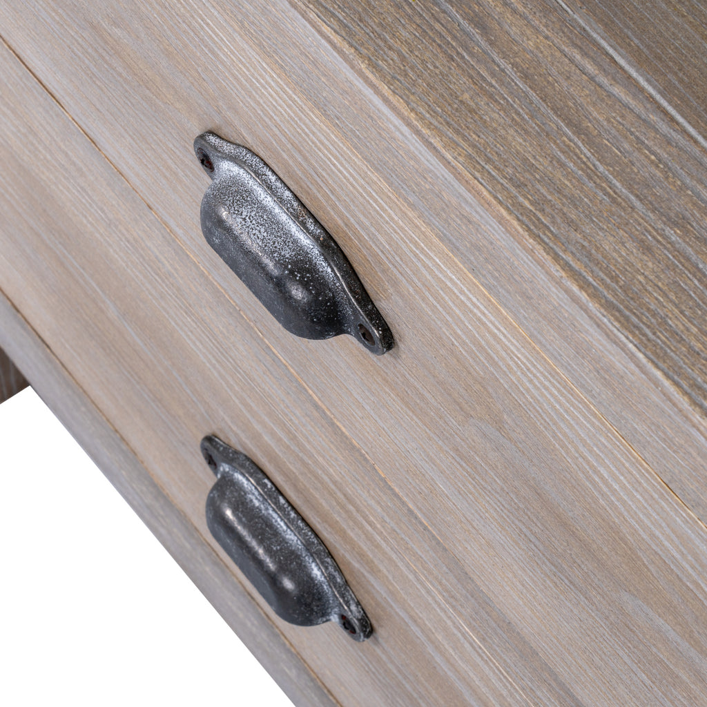 Close-up of the two dark, mottled cup-shaped drawer handles against pale brown fronts with white-highlighted grain.