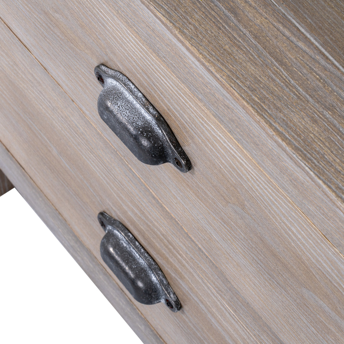 Close-up of the two dark, mottled cup-shaped drawer handles against pale brown fronts with white-highlighted grain.