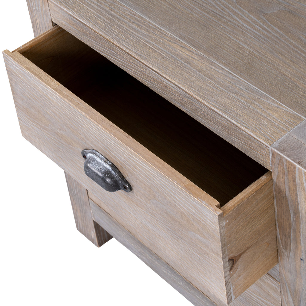 Angled close-up of the bedside table with its upper drawer open beneath the white-highlighted grain of the bordered top.
