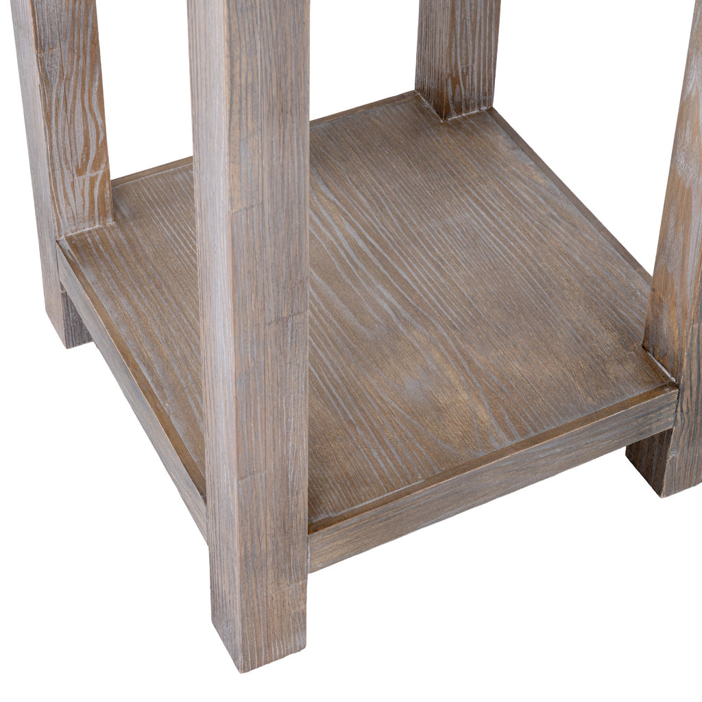 Close-up of the low square shelf between the straight legs, showing white grain highlights across the pale brown surface.