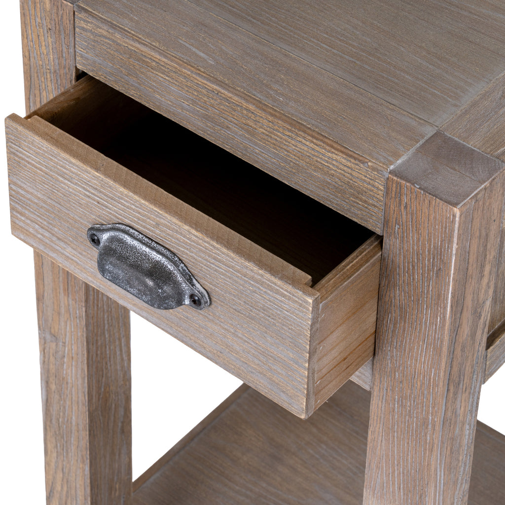 Close view of the drawer pulled open beneath the bordered top, with a dark mottled cup pull on the pale grain front.