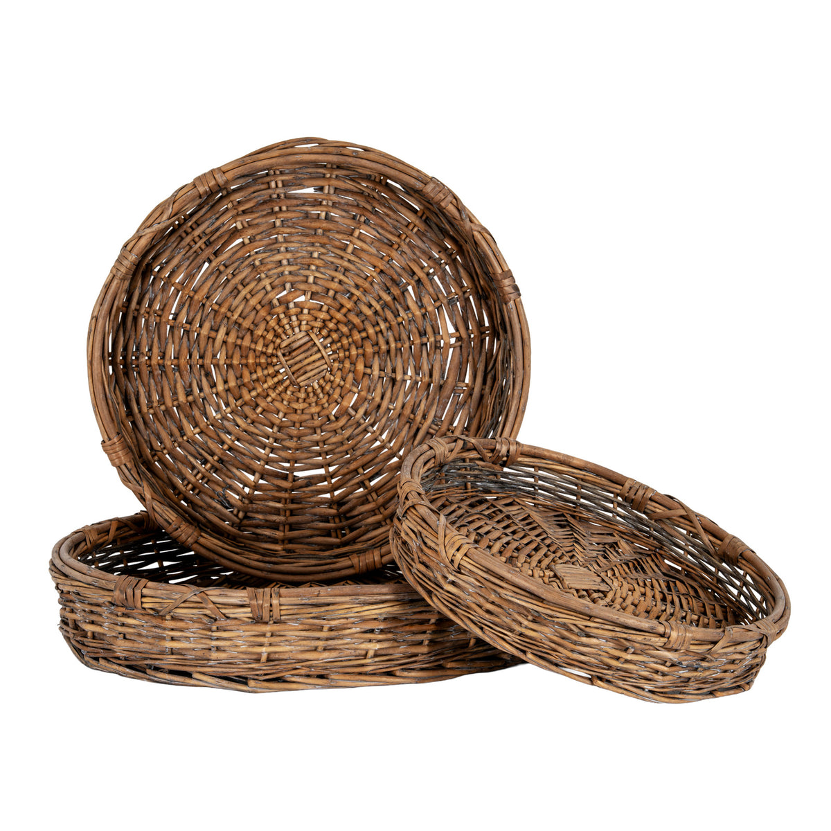 Three differently sized round brown woven trays, with one standing upright behind a flat tray and a smaller tray tilted at the front, showing bound rims and concentric woven bases.